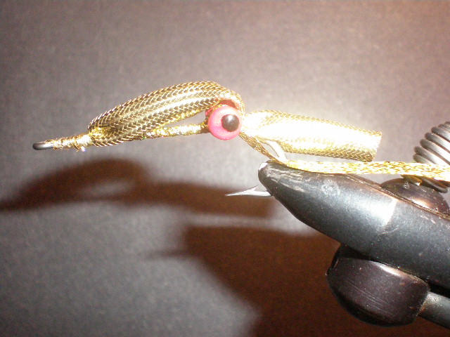 Fly with rattle inserted, body wrapped forward and braid tied off 